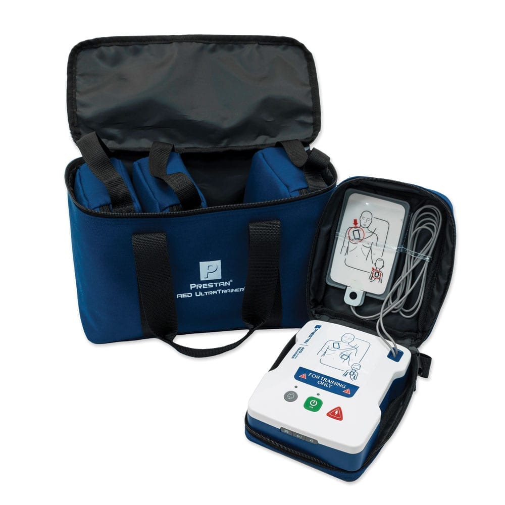 A Prestan AED trainier opened with the carry case displayed.