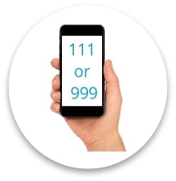 a phone being held in the right hand with the text " 111 or 999" on the screen