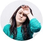 A lady in a blue jumper that looks tired.